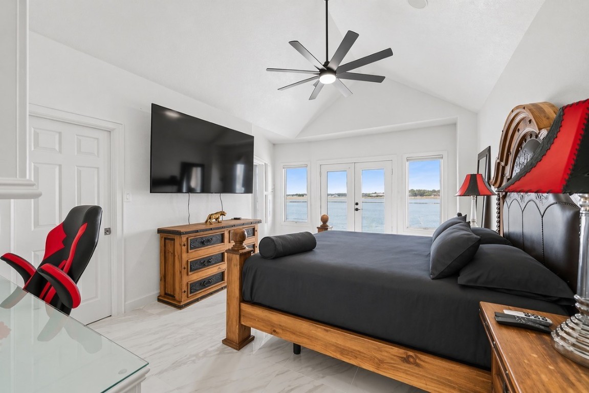 2500 Sand Shore Drive Conroe, TX 77304 - Photo 41 of 50 a bedroom with a bed and a flat screen tv