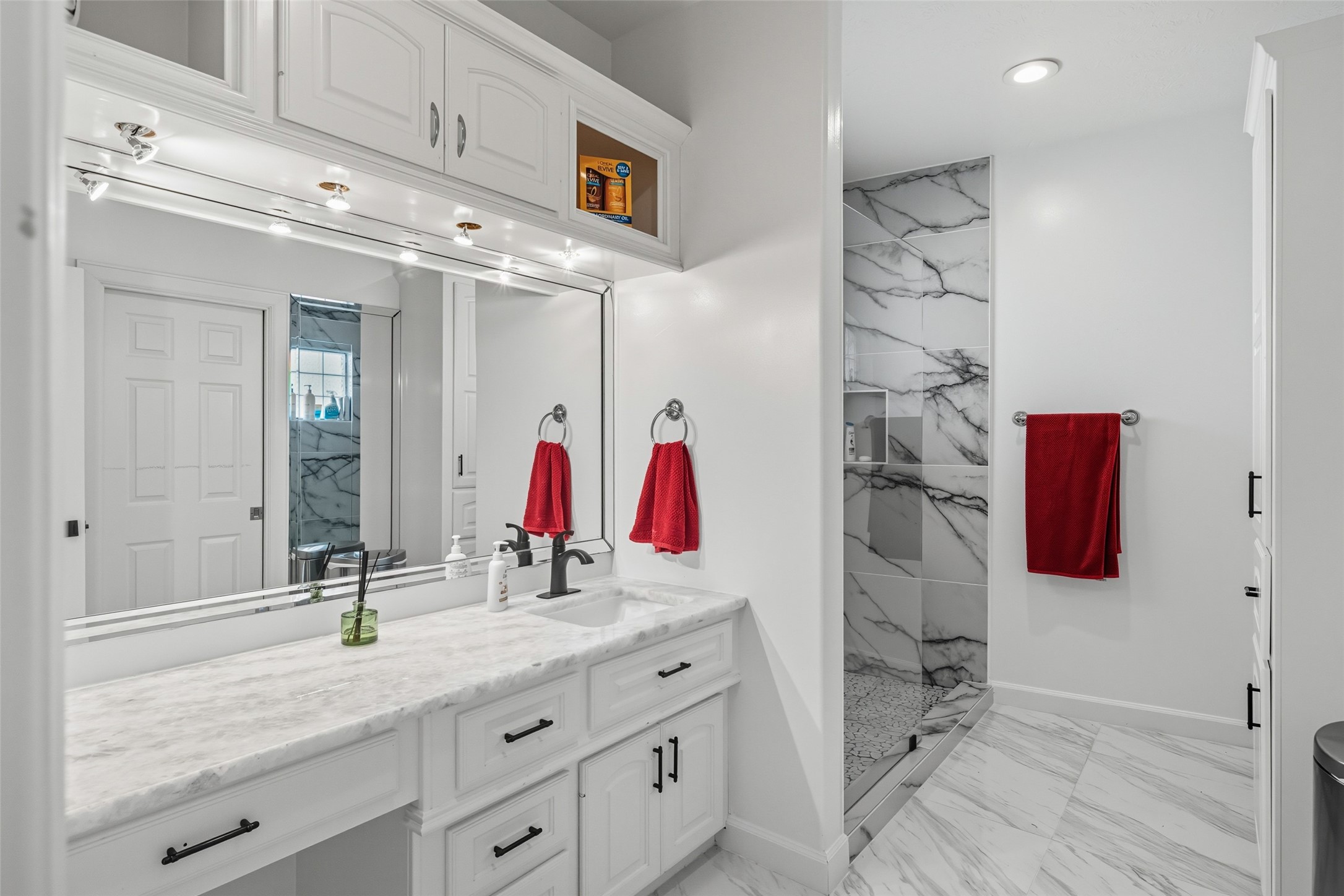 2500 Sand Shore Drive Conroe, TX 77304 - Photo 43 of 50 a bathroom with a granite countertop sink and a mirror