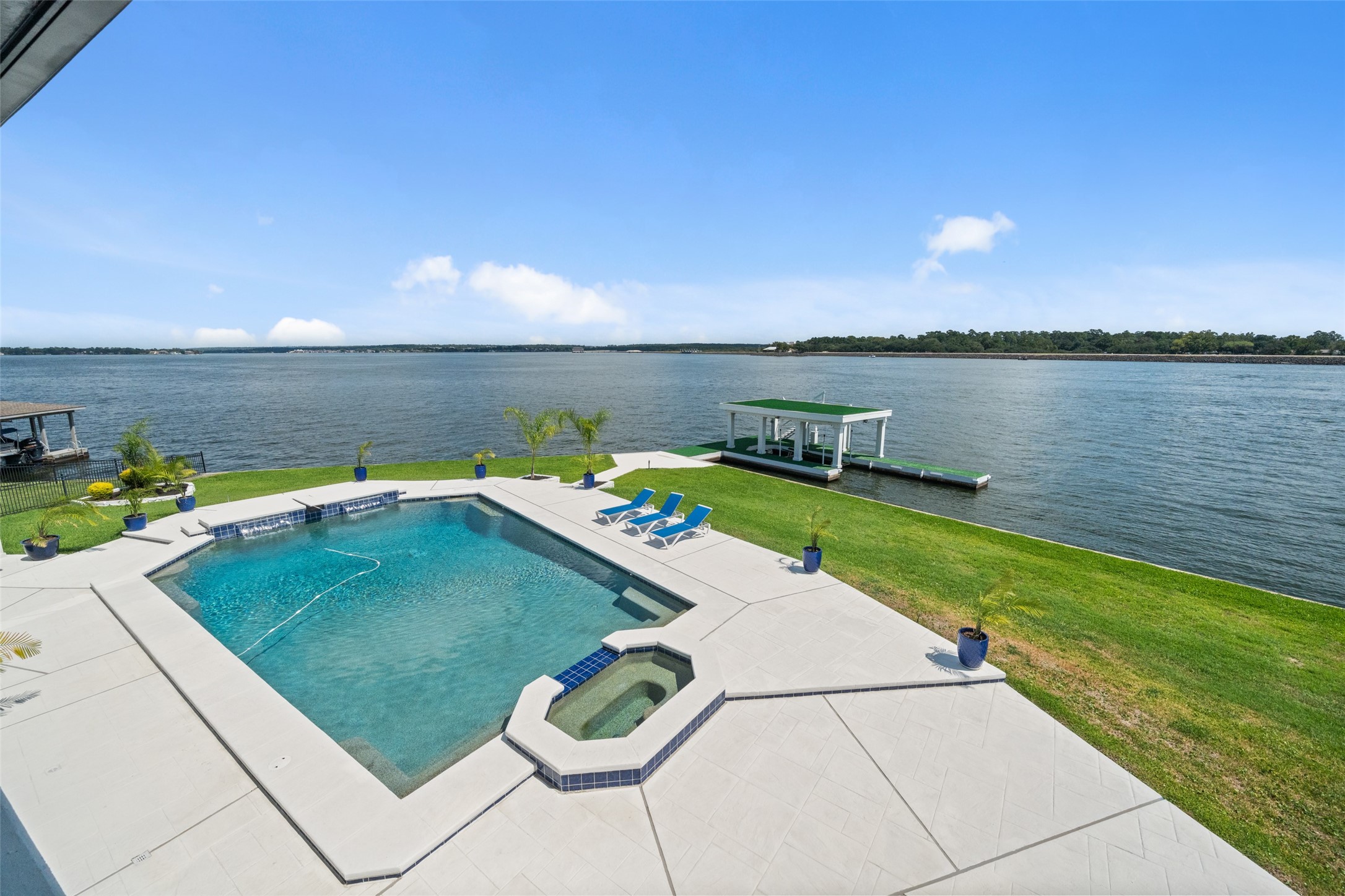2500 Sand Shore Drive Conroe, TX 77304 - Photo 5 of 50 Unobstructive views from the back of the home. The upper balcony spans the length of the home and overlooks the 44,000 gallon pool that is 10'-12' deep!