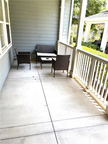 a view of a patio with table and chairs and wooden floor