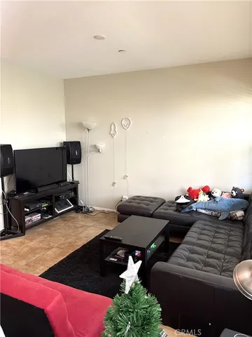 a bedroom with furniture and a flat screen tv