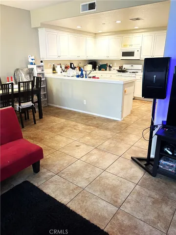 a view of kitchen with stainless steel appliances kitchen island granite countertop a stove a sink and a refrigerator