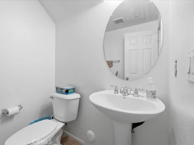 a bedroom with a bed and a computer on a desk