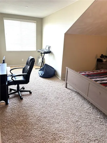 a living room with furniture and a chair