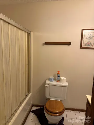a white toilet sitting next to a bathroom sink