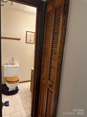 a bathroom with a toilet and a shower curtain