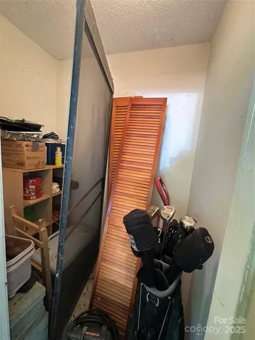 a view of a hallway with wooden floor and stairs