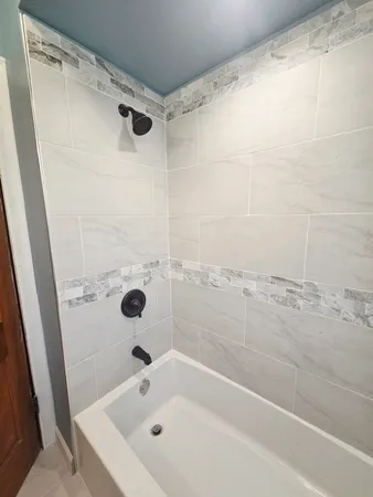 a bathroom with a tub and a shower