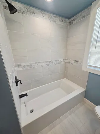 a bathroom with a tub and a shower