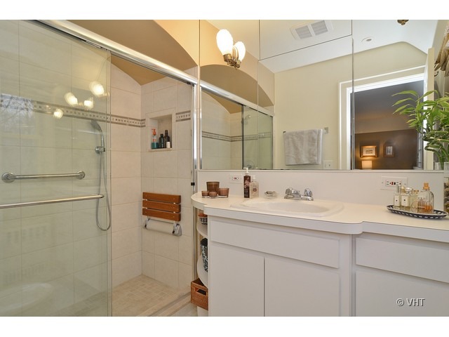 3025 Normandy Place Evanston, IL 60201 - Photo 16 of 24 a bathroom with a double vanity sink mirror and shower