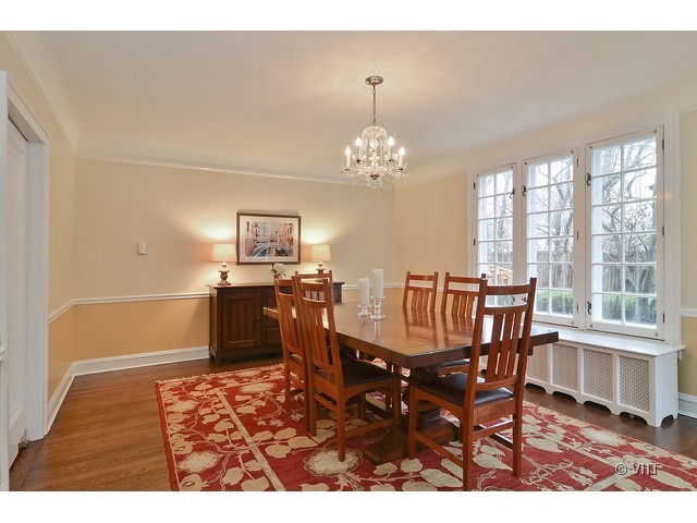 3025 Normandy Place Evanston, IL 60201 - Photo 6 of 24 a dining room with chandelier and wooden floor