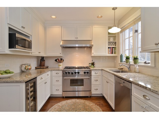 3025 Normandy Place Evanston, IL 60201 - Photo 9 of 24 a kitchen with stainless steel appliances granite countertop a stove a sink and a microwave