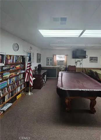 a bed room with furniture and a book shelf