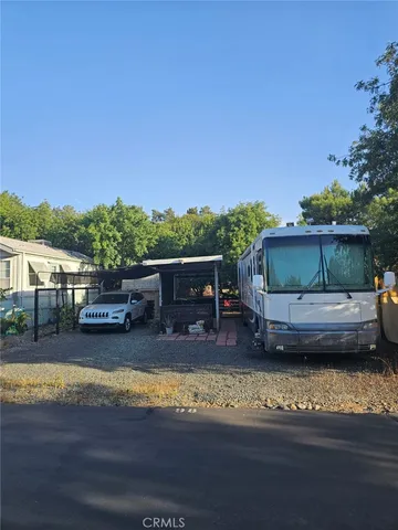 a view of house with swimming pool and a yard