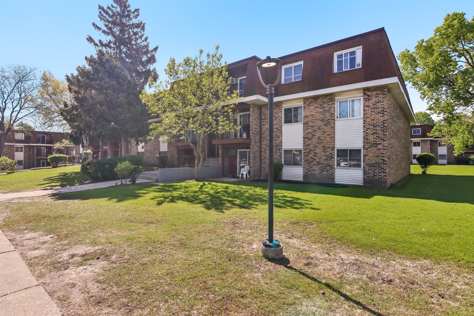 615 Hill Drive, Unit 303 Hoffman Estates, IL 60169 - Photo 1 of 1 a sign board on the side of the house