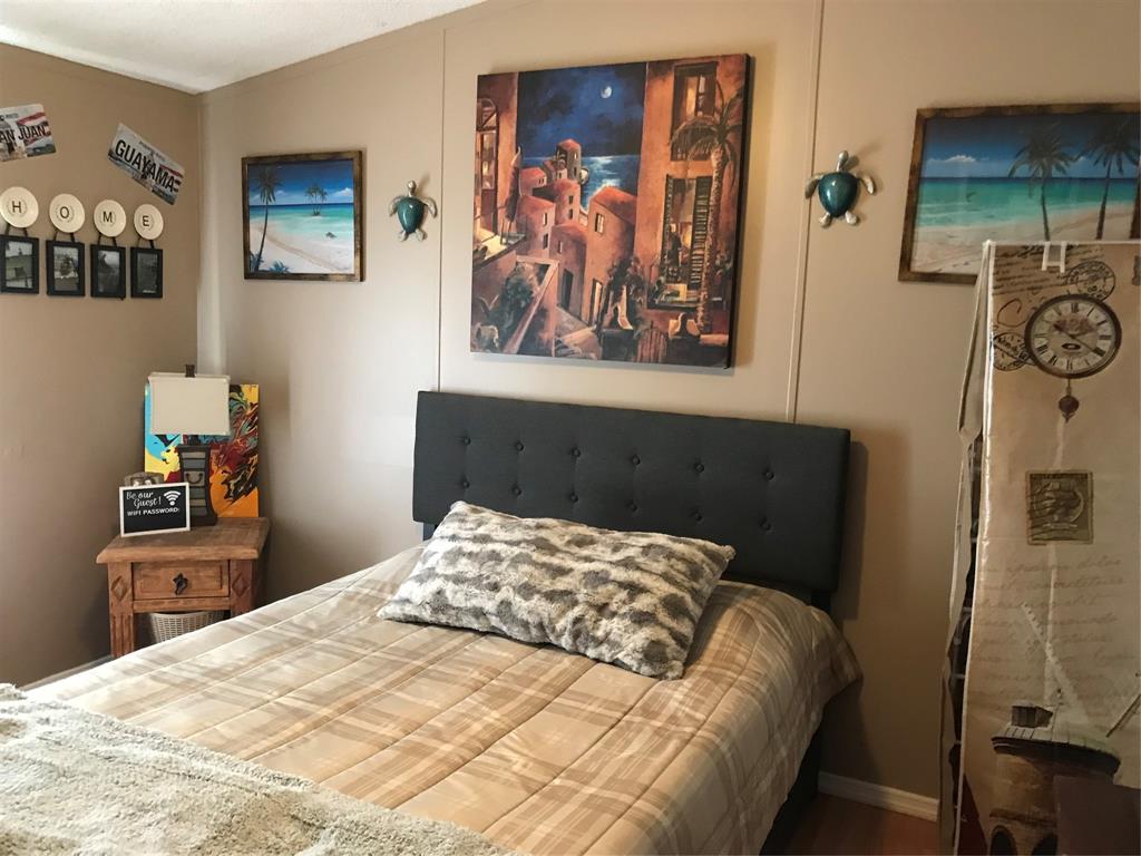 1192 Chobee Street Okeechobee, FL 34974 - Photo 11 of 18 a bedroom with a bed and the wall painting