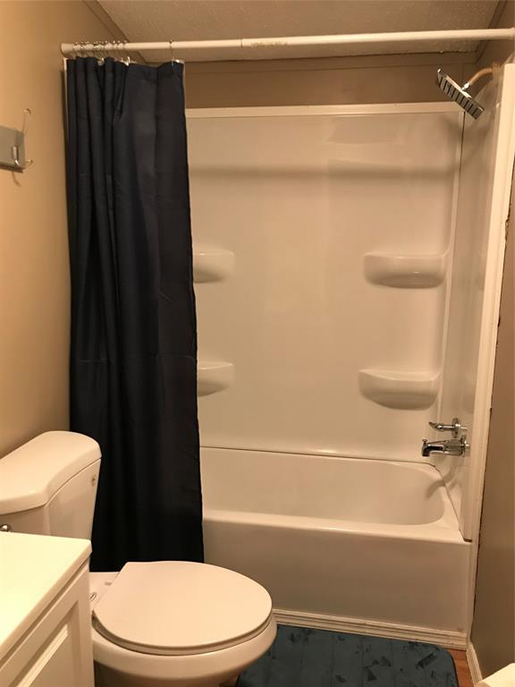 1192 Chobee Street Okeechobee, FL 34974 - Photo 12 of 18 a white toilet sitting next to a bath tub