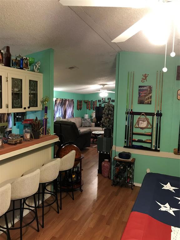 1192 Chobee Street Okeechobee, FL 34974 - Photo 6 of 18 a living room with furniture and a flat screen tv