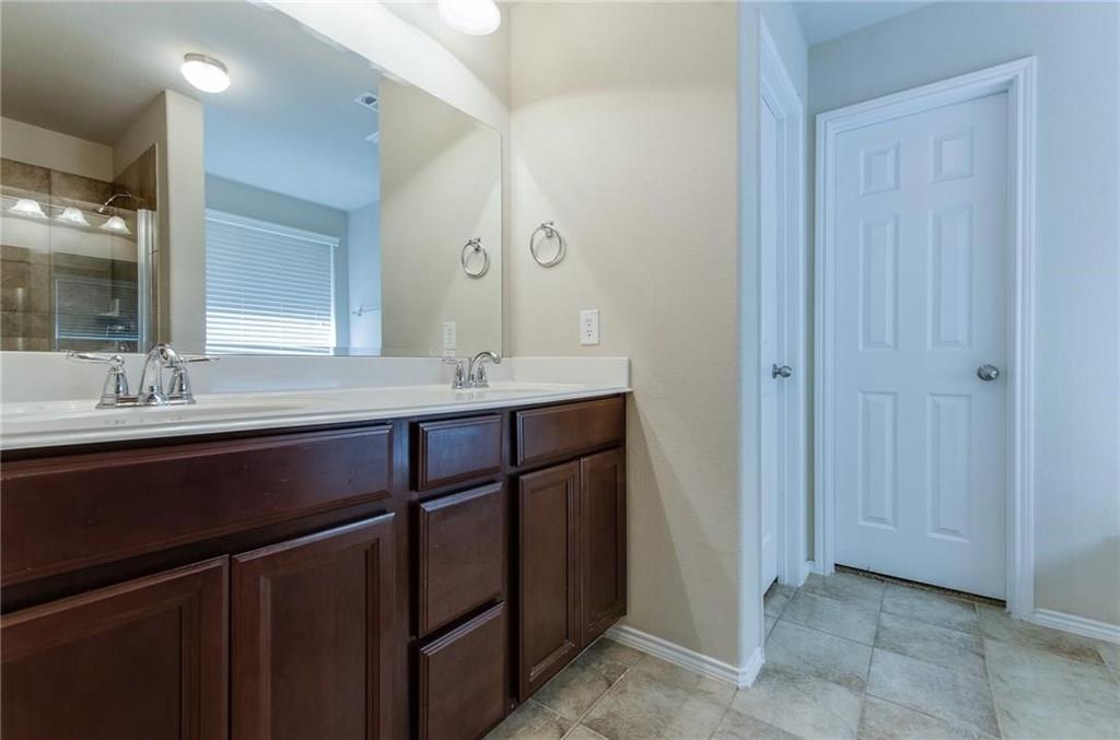 3404 Evening Wind Road Denton, TX 76208 - Photo 19 of 24 a bathroom with a double vanity sink and a mirror