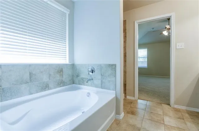 a bathroom with a bathtub and shower