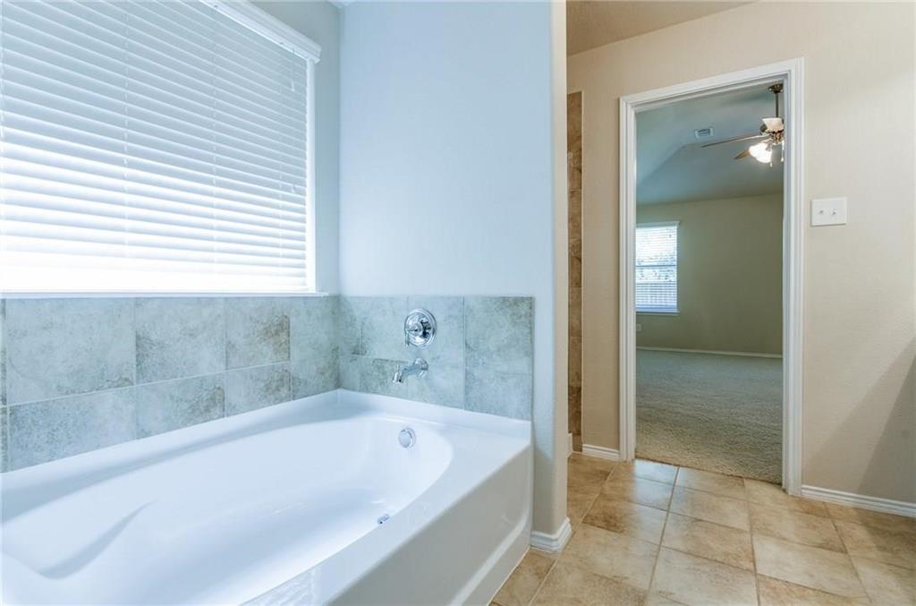 3404 Evening Wind Road Denton, TX 76208 - Photo 20 of 24 a bathroom with a bathtub and shower