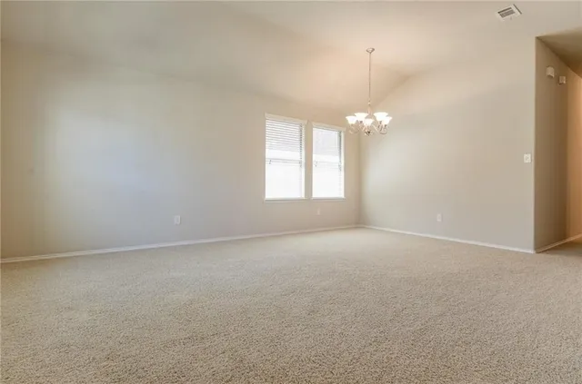 a view of a chandelier and window in an empty room