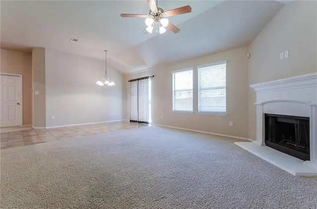 a view of empty room with window and fireplace