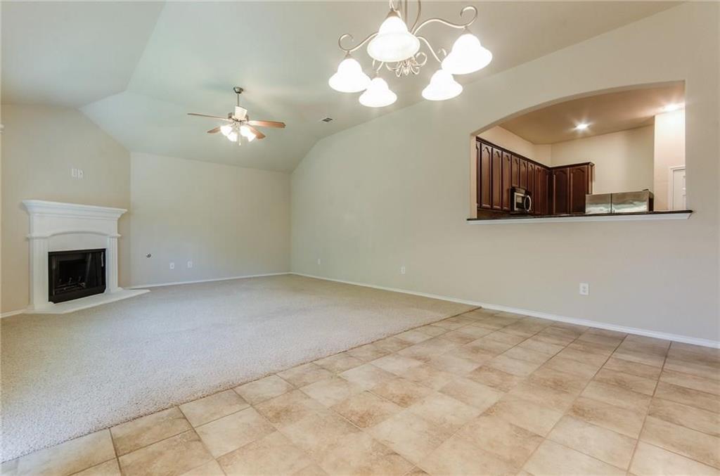 3404 Evening Wind Road Denton, TX 76208 - Photo 10 of 24 a view of a kitchen with a dishwasher cabinets and a fireplace