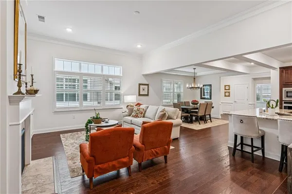 a living room with furniture a fireplace and wooden floor