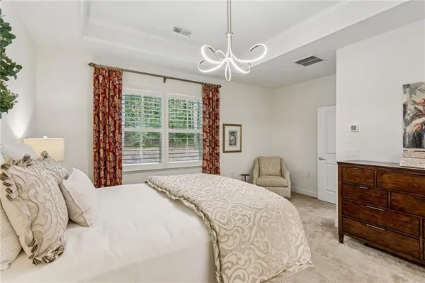 a bedroom with a large bed and a dresser