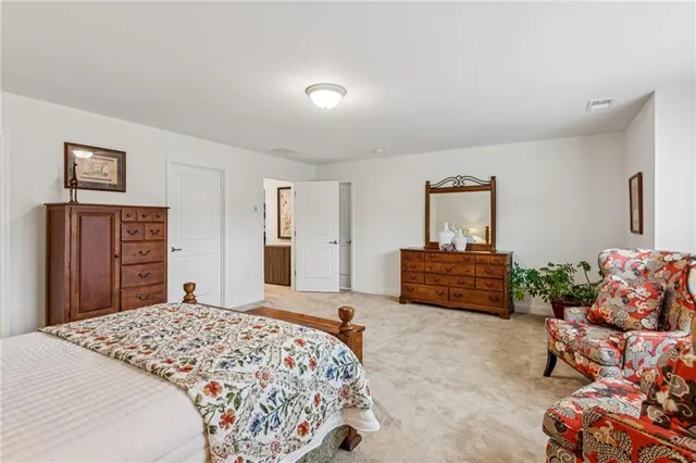 a bedroom with a bed and a couch