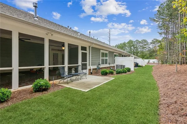 a view of a house with backyard and sitting area