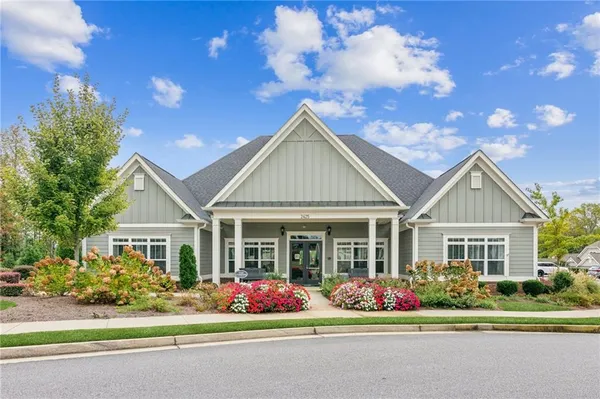 a front view of a house with a garden
