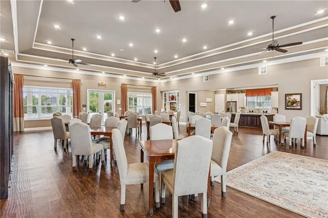 a very nice looking dining room with lots of furniture and wooden floor