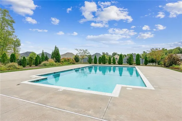 a view of a swimming pool and trees in the background