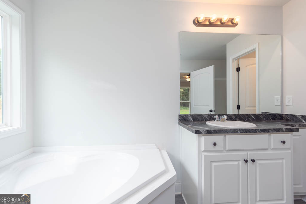 526 Oil Mill Road, Unit 9 Martin, GA 30557 - Photo 22 of 27 a bathroom with a granite countertop sink and a mirror