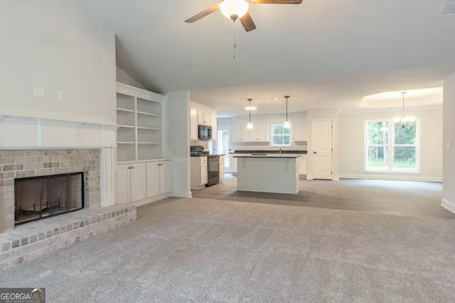a view of a kitchen with a stove cabinets and a fireplace