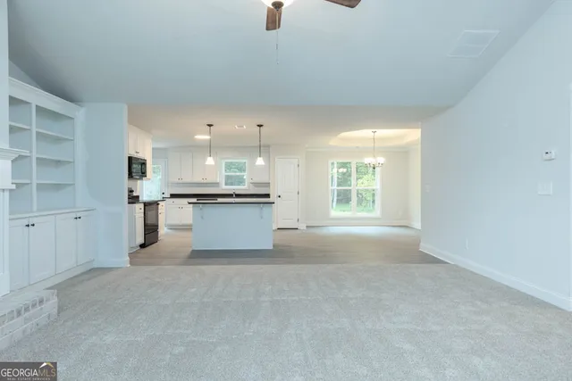 a view of a kitchen with a sink and cabinets