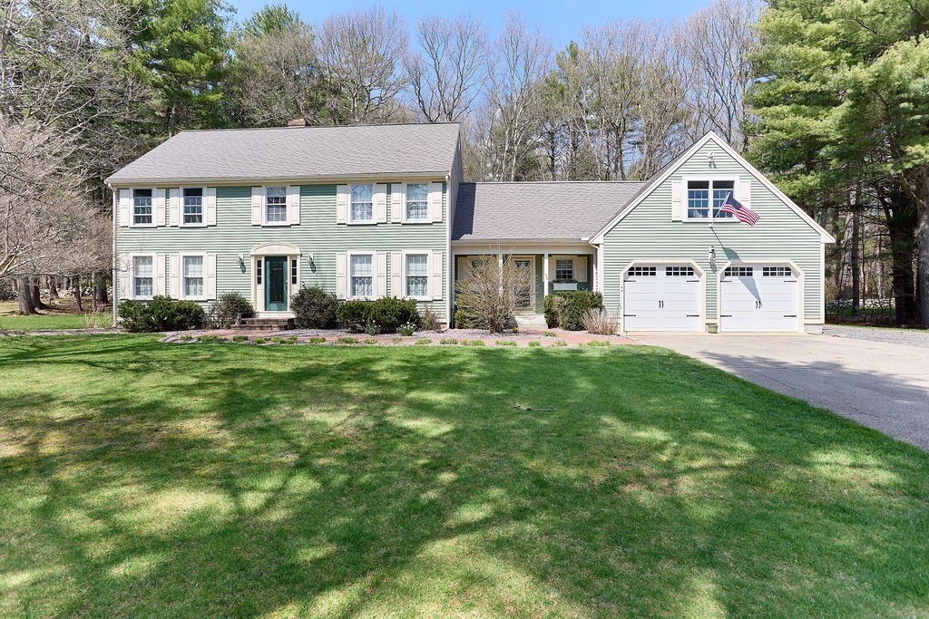 58 Buttercup Lane Hanover, MA 02339 - Photo 2 of 35 a front view of a house with a yard and trees