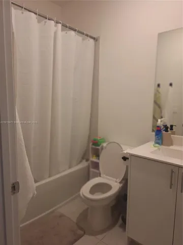 a bathroom with a toilet and shower