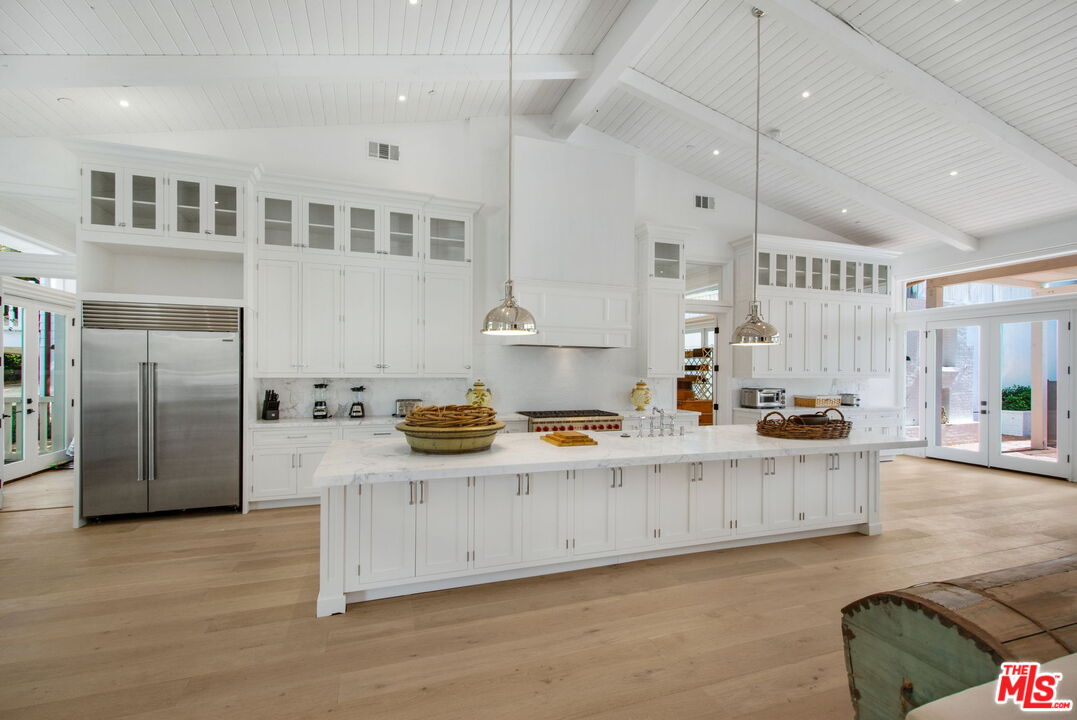 9669 Oak Pass Road Beverly Hills, CA 90210 - Photo 2 of 37 a kitchen with stainless steel appliances granite countertop a stove and a refrigerator