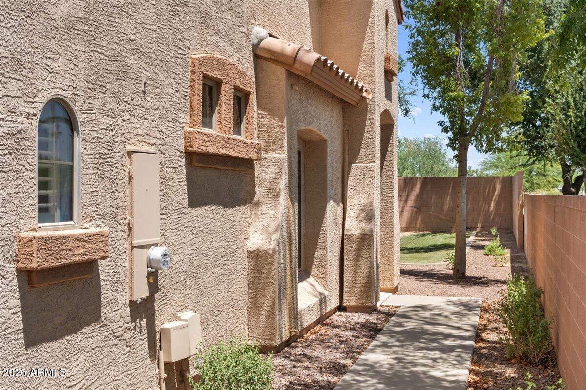 2600 East Springfield Place, Unit 87 Chandler, AZ 85286 - Photo 2 of 40 02-Walkway to home and back yard is fenc