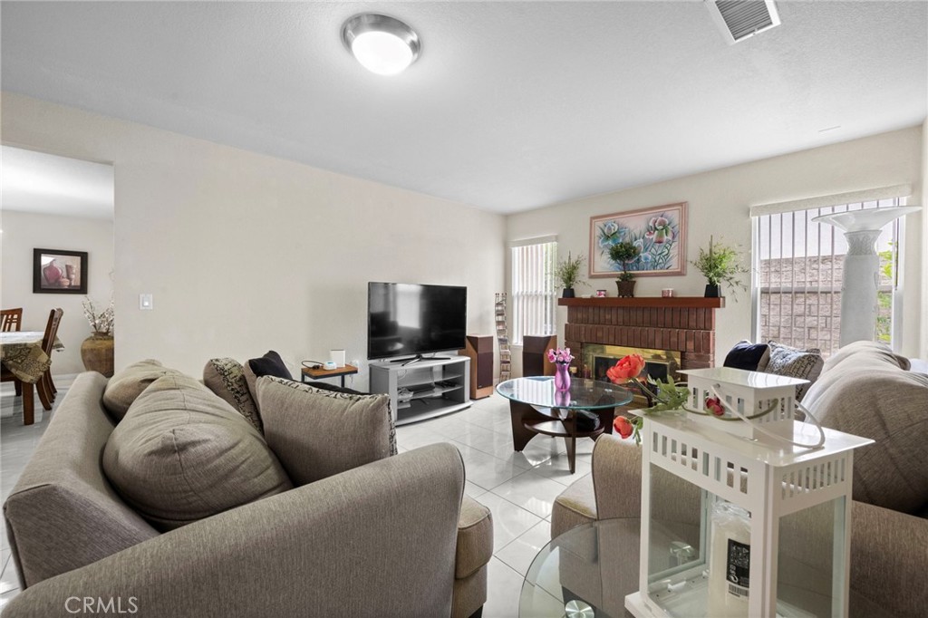 605 Bronco Way Walnut, CA 91789 - Photo 25 of 69 a living room with furniture a fireplace and a flat screen tv