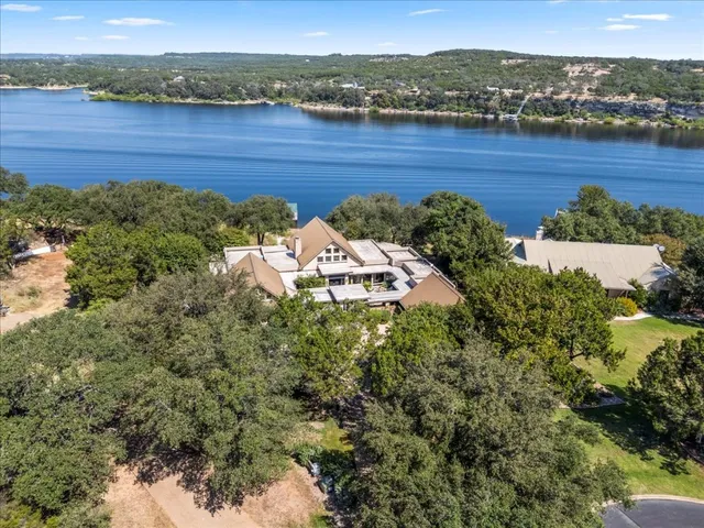an aerial view of a house with a yard