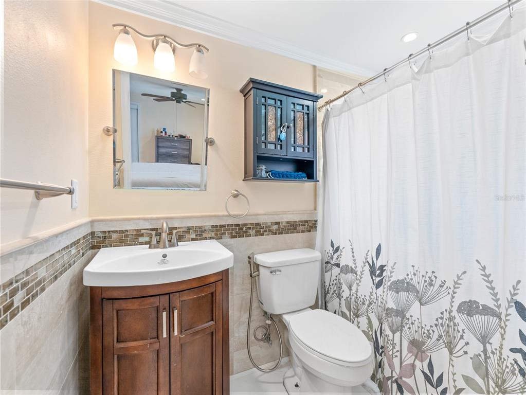 4237 Redcliff Place New Port Richey, FL 34652 - Photo 18 of 25 a bathroom with a sink a toilet and shower curtain