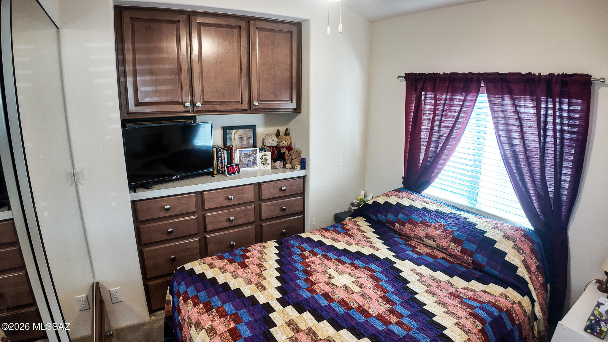 1030 Barrel Cactus Ridge, Unit 230 Benson, AZ 85602 - Photo 7 of 12 a bedroom with a bed and a television