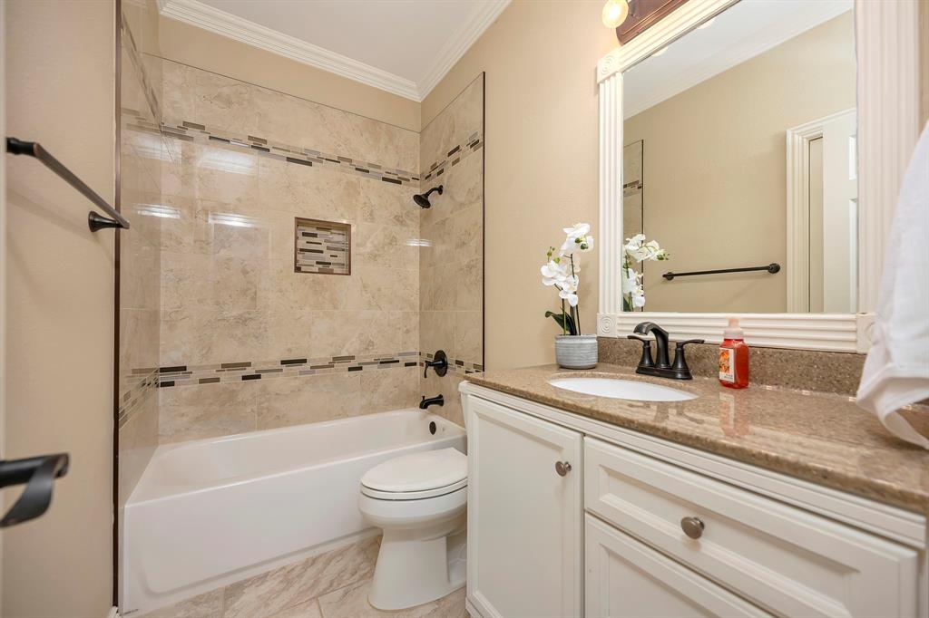 4008 Ramsgate Court Colleyville, TX 76034 - Photo 7 of 33 2nd Bathroom downstairs battub/showecombination with tiled surround, glass shower panel, and decorative mosaic tile accents