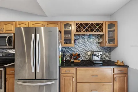 a kitchen with stainless steel appliances granite countertop a refrigerator and a stove