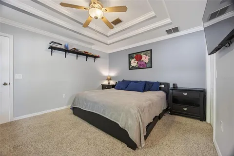 a bedroom with a bed and a chandelier