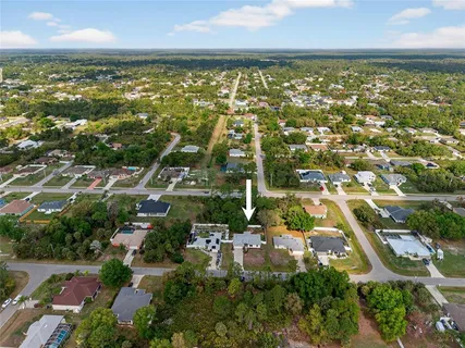an aerial view of residential building and lake